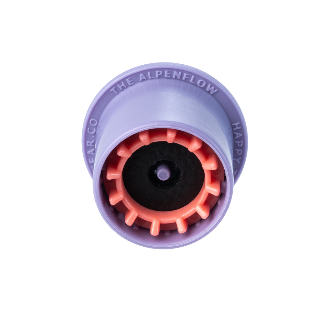 The Alpenflow is a purple and red rounded device shown on a white background that transfers fuel between 2 backpacking fuel canisters