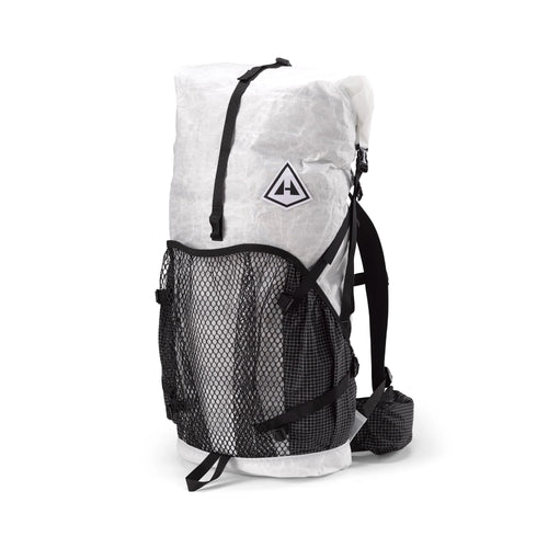 Hyperlite Mountain Gear's Ultralight backpack with a mesh center exterior pocket and two solid-fabric side exterior pockets, predominantly white with black straps and mesh.
