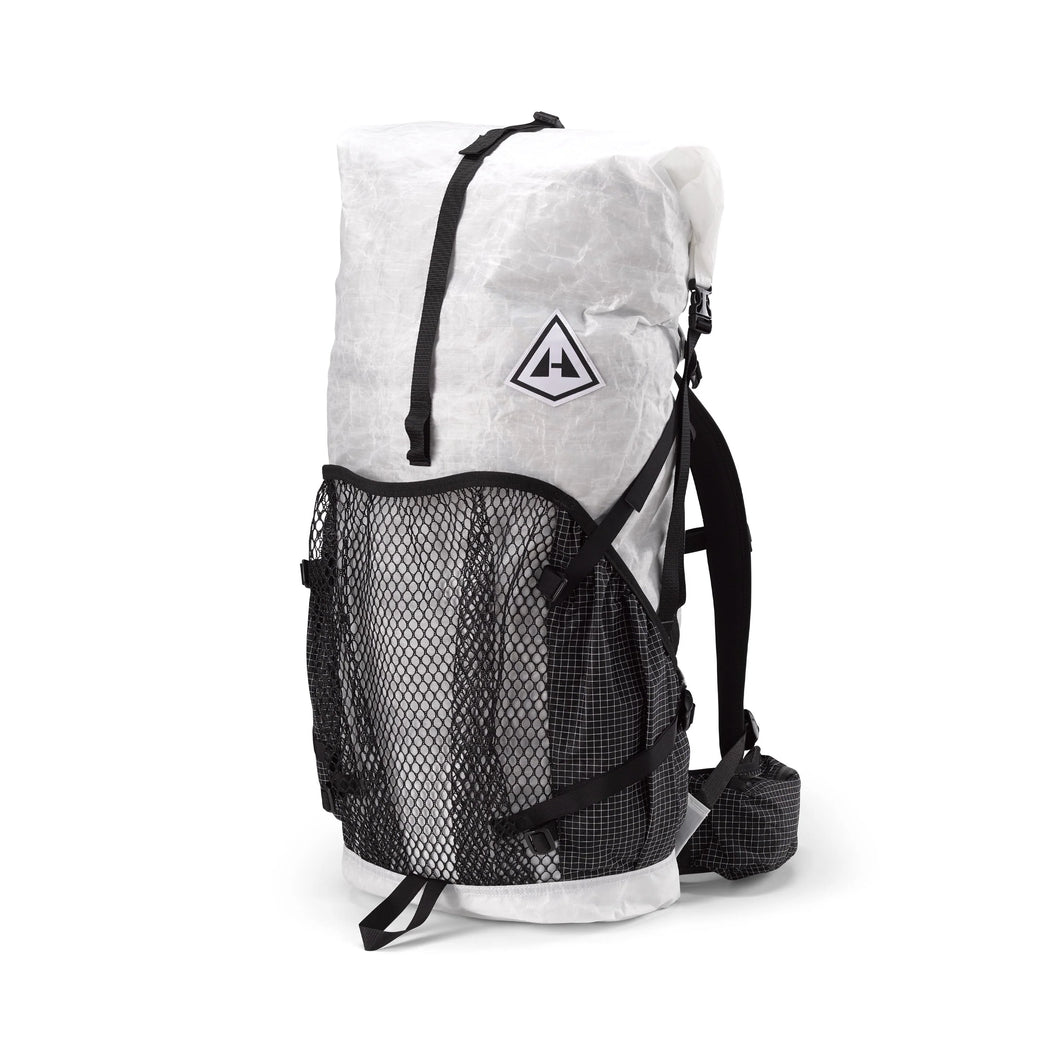 Hyperlite Mountain Gear's Ultralight backpack with a mesh center exterior pocket and two solid-fabric side exterior pockets, predominantly white with black straps and mesh.