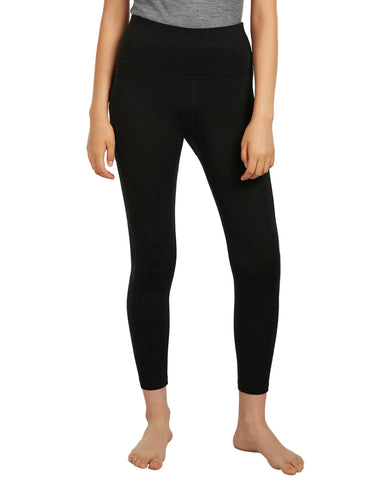 Woman wearing black Icebreaker Merino Wool 260 weight Fastray II leggings on a white background