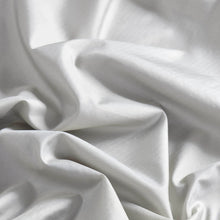 Close-up of white fabric of silk sleeping bag liner