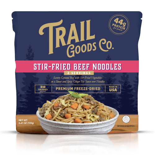 Packaging of Trail Goods Co. Stir-Fried Beef Noodles with a bowl of noodles on a white background